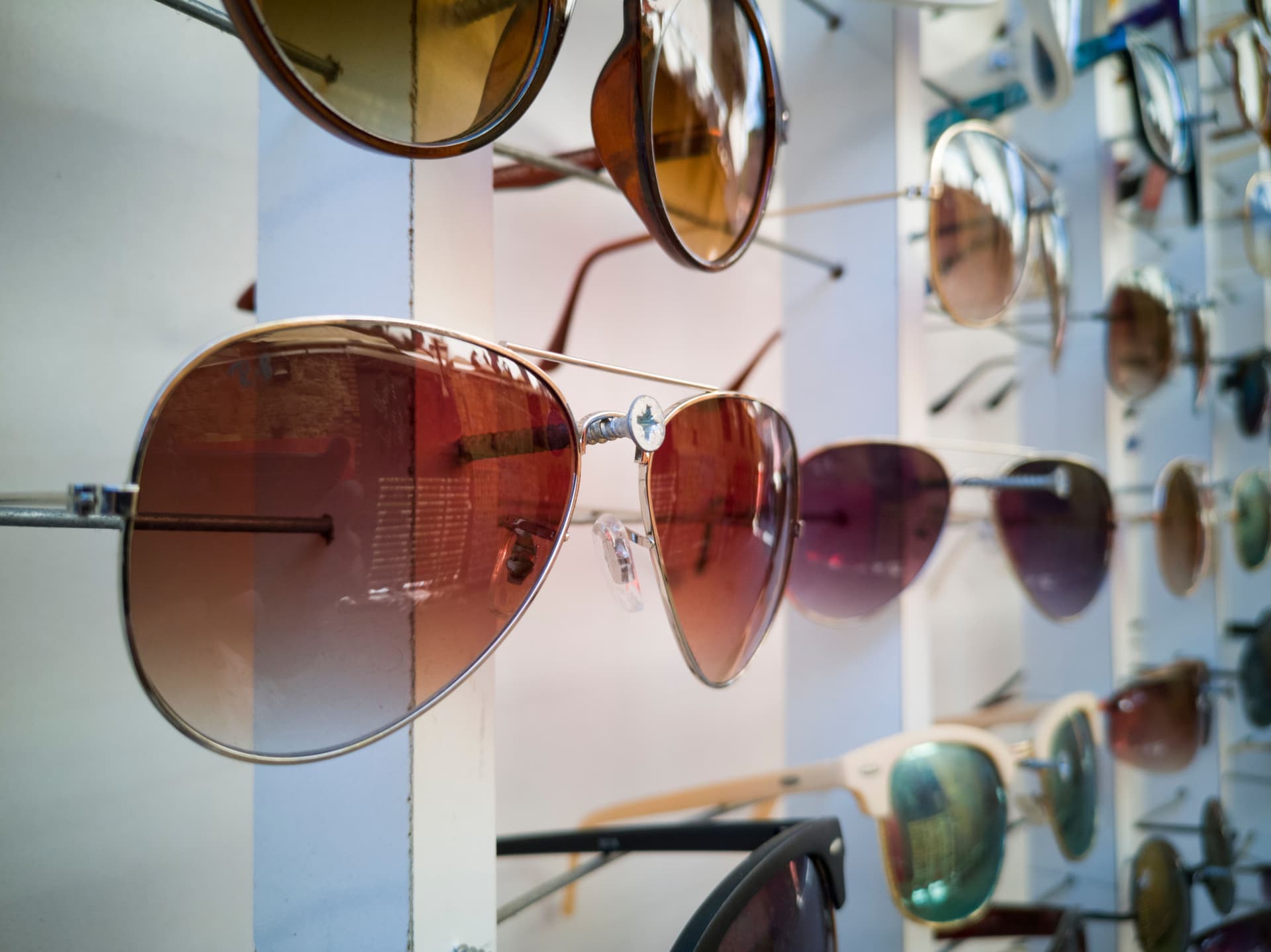 A display of sunglasses in many styles and lens colors