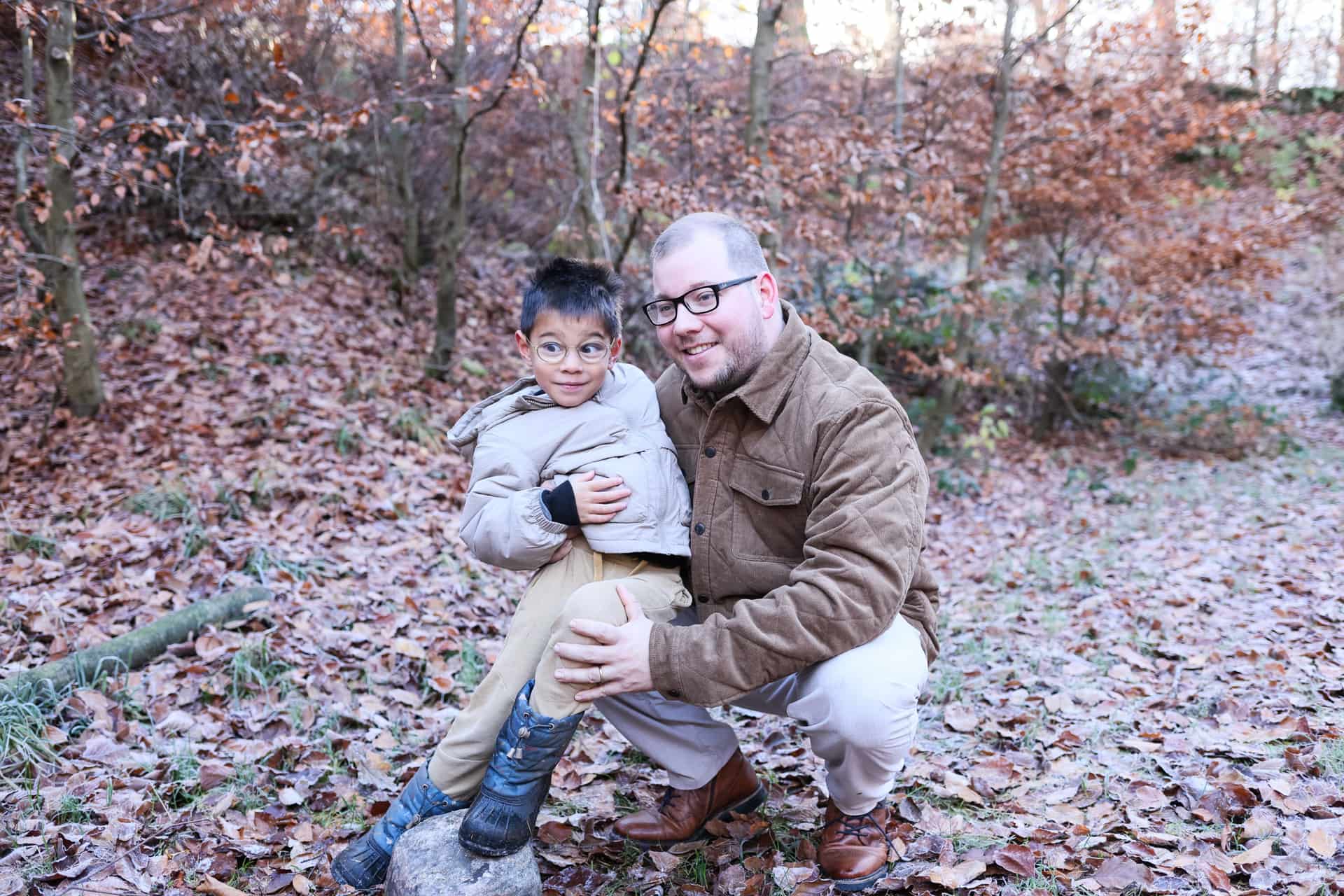 A father and son together in an autumn forest